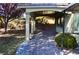 Covered patio with brick pavers, pillars, and nicely landscaped yard at 4047 Cougar Falls Ct, North Las Vegas, NV 89085