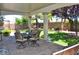 Covered patio with dining set overlooking the meticulously landscaped backyard at 4047 Cougar Falls Ct, North Las Vegas, NV 89085