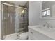 This bathroom features a tiled shower with glass doors and a modern vanity at 413 Pumpkin Way, Henderson, NV 89015