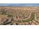 Expansive aerial view of a vibrant residential community, showcasing its well-planned layout and desert landscape with city skyline at 4384 Grey Spencer Dr, Las Vegas, NV 89141