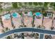Bird's-eye view of multiple homes, each featuring swimming pools and well-maintained landscaping at 4384 Grey Spencer Dr, Las Vegas, NV 89141