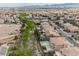 Extensive aerial view of a neighborhood with mature trees, community spaces, and a variety of home styles at 4384 Grey Spencer Dr, Las Vegas, NV 89141
