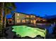 Home exterior view with in-ground pool illuminated at night, showcasing the landscaped backyard at 4384 Grey Spencer Dr, Las Vegas, NV 89141