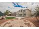 Backyard features brick pavers, artificial turf, pool and covered seating at 4384 Grey Spencer Dr, Las Vegas, NV 89141
