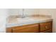 Bathroom sink showcasing tiled countertops and wood cabinets at 4384 Grey Spencer Dr, Las Vegas, NV 89141