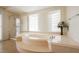 Elegant bathroom featuring a soaking tub, glass shower, and natural light at 4384 Grey Spencer Dr, Las Vegas, NV 89141