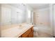 Bright bathroom features a shower-tub combo with a white sink and wood cabinet at 4384 Grey Spencer Dr, Las Vegas, NV 89141