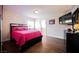 Bedroom with wood floors, a pink bedspread, TV and a view of a bathroom at 4384 Grey Spencer Dr, Las Vegas, NV 89141