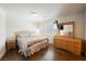 Bedroom features hardwood flooring with a king bed, shutters, and wooden dresser at 4384 Grey Spencer Dr, Las Vegas, NV 89141