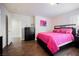 Bedroom featuring wood floors, a pink bedspread, and a black dresser at 4384 Grey Spencer Dr, Las Vegas, NV 89141