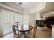 Cozy dining room area with a fireplace and natural light streaming through the shutters at 4384 Grey Spencer Dr, Las Vegas, NV 89141