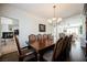 Formal dining room with a large wooden table, chandelier, and access to the living room at 4384 Grey Spencer Dr, Las Vegas, NV 89141