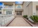 Close up of a home's detailed entrance with lush landscaping and a paved walkway at 4384 Grey Spencer Dr, Las Vegas, NV 89141