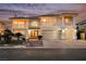 Two-story home with a three-car garage, tile roof, and manicured landscaping at 4384 Grey Spencer Dr, Las Vegas, NV 89141
