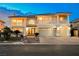 Elegant two-story home with a tile roof, three-car garage, and landscaped front yard at 4384 Grey Spencer Dr, Las Vegas, NV 89141