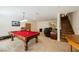 Expansive game room with a pool table, office space, and staircase to the upper level at 4384 Grey Spencer Dr, Las Vegas, NV 89141