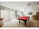 Spacious game room with a pool table, carpeted floors, and natural light from the sliding glass door at 4384 Grey Spencer Dr, Las Vegas, NV 89141