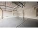 Spacious garage with epoxy flooring, white walls, storage cabinets, and ample parking space at 4384 Grey Spencer Dr, Las Vegas, NV 89141