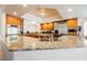 Open kitchen with granite countertops, stainless steel appliances, and custom wood cabinets at 4384 Grey Spencer Dr, Las Vegas, NV 89141
