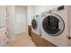 Well-equipped laundry room featuring modern washer and dryer units and ample storage space at 4384 Grey Spencer Dr, Las Vegas, NV 89141