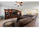 Inviting living room with a large sectional couch and custom built-in entertainment center at 4384 Grey Spencer Dr, Las Vegas, NV 89141