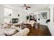 Cozy living room with hardwood floors, a fireplace, and decorative columns at 4384 Grey Spencer Dr, Las Vegas, NV 89141