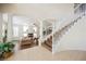 Bright living room featuring tile flooring and a staircase with white railings at 4384 Grey Spencer Dr, Las Vegas, NV 89141