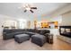 Open-concept living room featuring tile flooring, a fireplace, and a kitchen in the background at 4384 Grey Spencer Dr, Las Vegas, NV 89141