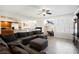 Open-concept living area with tile flooring, a fireplace, and an adjacent kitchen at 4384 Grey Spencer Dr, Las Vegas, NV 89141