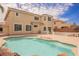 Backyard pool of home, featuring waterfall, palm trees and beautiful landscaping at 4384 Grey Spencer Dr, Las Vegas, NV 89141