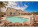Backyard pool of home, featuring waterfall, palm trees and beautiful landscaping at 4384 Grey Spencer Dr, Las Vegas, NV 89141