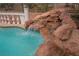 Pool waterfall surrounded by rocks adding to the unique backyard space at 4384 Grey Spencer Dr, Las Vegas, NV 89141