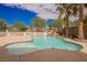 Backyard pool features waterfall, palm trees and beautiful landscaping at 4384 Grey Spencer Dr, Las Vegas, NV 89141