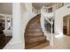 Grand staircase with wood treads, white risers, and an elegant curved banister at 4384 Grey Spencer Dr, Las Vegas, NV 89141