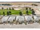 Community aerial showcasing multiple single-story homes and lush green golf course at 4772 Se Argent Hills Ave, Pahrump, NV 89061