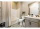 Well-lit bathroom features a shower-tub combo with neutral tile surround and a vanity with ample storage at 4772 Se Argent Hills Ave, Pahrump, NV 89061