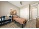 Cozy bedroom with wood-look floors, a small bed, and a convenient closet for storage at 4772 Se Argent Hills Ave, Pahrump, NV 89061