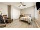 Charming bedroom featuring a ceiling fan, wood-look flooring, and a cozy armchair at 4772 Se Argent Hills Ave, Pahrump, NV 89061