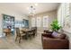 Formal dining room features a large wood table and chairs, plantation shutters, and hardwood floors at 4772 Se Argent Hills Ave, Pahrump, NV 89061