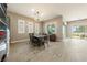 Elegant dining room with a modern chandelier, plantation shutters, and seamless access to the backyard at 4772 Se Argent Hills Ave, Pahrump, NV 89061