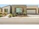 Modern home featuring a desert landscaped front yard and a two car garage at 4772 Se Argent Hills Ave, Pahrump, NV 89061