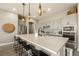 Bright kitchen features a large island, stainless steel appliances, and stylish pendant lighting at 4772 Se Argent Hills Ave, Pahrump, NV 89061