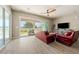 Living room with tile floors, comfortable couches and large sliding glass doors at 4772 Se Argent Hills Ave, Pahrump, NV 89061