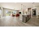 Spacious open-concept living space featuring a kitchen, dining area, and living room with backyard access at 4772 Se Argent Hills Ave, Pahrump, NV 89061