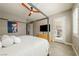 Spacious main bedroom with four-poster bed, ceiling fan and stylish decor and access to outside at 4772 Se Argent Hills Ave, Pahrump, NV 89061