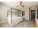 Bright main bedroom featuring wood-look tile flooring, a ceiling fan and decor touches at 4772 Se Argent Hills Ave, Pahrump, NV 89061