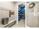 View of the entryway showing a well-stocked pantry with blue shelving and decor touches at 4772 Se Argent Hills Ave, Pahrump, NV 89061