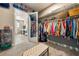 Large walk-in closet with extensive shelving and hanging space, connected to a bright bathroom at 4772 Se Argent Hills Ave, Pahrump, NV 89061