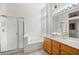 Clean bathroom featuring a shower, soaking tub, and double vanity with wood cabinets at 482 Bonnie Brook Pl, Henderson, NV 89012