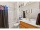 Well-lit bathroom featuring a shower-tub combo, neutral tiling, and a single sink vanity at 482 Bonnie Brook Pl, Henderson, NV 89012